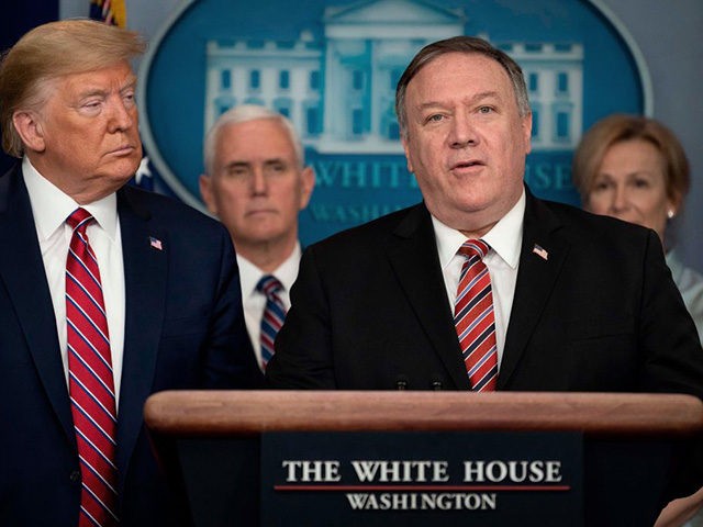 US President Donald Trump listens as Secretary of State Mike Pompeo speaks during the daily briefing on the novel coronavirus, COVID-19, at the White House on March 20, 2020, in Washington, DC. - Pompeo told China to make coronavirus details 'available to the whole world' (Photo by JIM WATSON / …