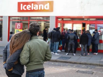 LONDON, ENGLAND - MARCH 21: People line up outside an Iceland supermarket on Roman Road in Bow on March 21, 2020 in London, England. Londoners are feeling the impact of shutdowns due to Coronavirus. Coronavirus (COVID-19) has spread to at least 186 countries, claiming over 11,000 lives and infecting more …