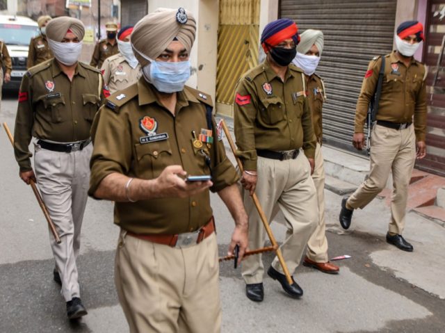 Police personnel patrol on a street during a government-imposed lockdown as a preventive measure against the COVID-19 coronavirus, in Amritsar on March 24, 2020. (Photo by NARINDER NANU / AFP) (Photo by NARINDER NANU/AFP via Getty Images)