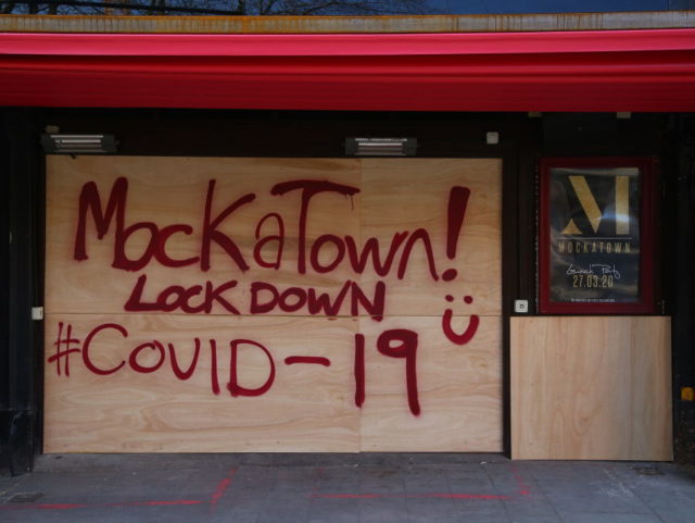 A sign in spray paint informs customers that the Mokatown launch party is cancelled due to the coronavirus outbreak in Cardiff on March 24, 2020 after Britain ordered a lockdown to slow the spread of the novel coronavirus. - Britain was under lockdown March 24, its population joining around 1.7 …