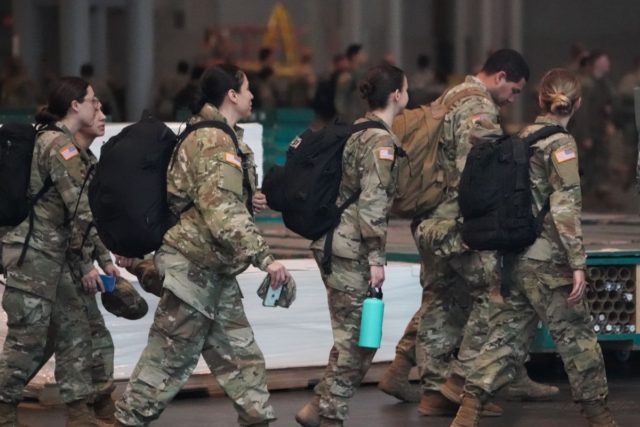 Members of the Army National Guard arrive to the Jacob K. Javits Center on March 27, 2020