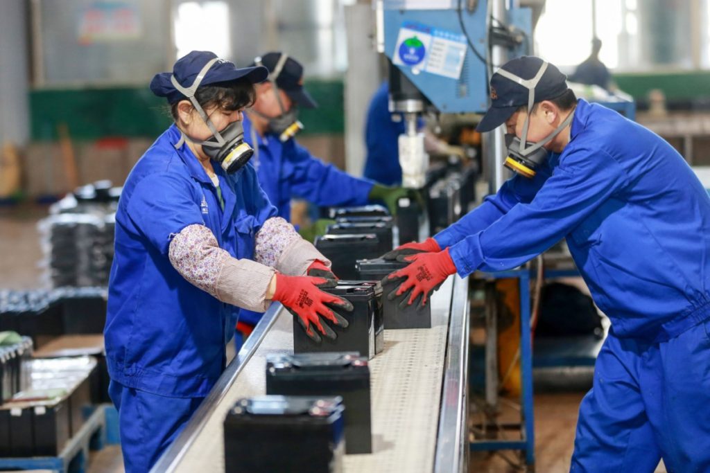 This photo taken on March 30, 2020 shows employees working on a battery production line at a factory in Huaibei in China's eastern Anhui province. - Factory activity in China rebounded in March from a record low, according to official data released on March 31, returning to expansion territory while the coronavirus pandemic continues to devastate the global economy. (Photo by STR / AFP) / China OUT (Photo by STR/AFP via Getty Images)