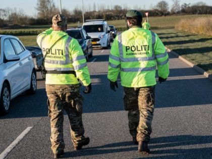 Police watch people queueing up in their cars at the recycling site for public waste on March 31, 2020 in Fredericia, Denmark, after recycling sites all over Denmark reopened following its closure by the government amid the Coronavirus Covid-19 lockdown for almost three weeks. (Photo by Claus Fisker / Ritzau …