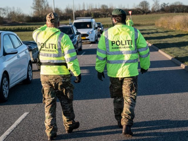 Police watch people queueing up in their cars at the recycling site for public waste on March 31, 2020 in Fredericia, Denmark, after recycling sites all over Denmark reopened following its closure by the government amid the Coronavirus Covid-19 lockdown for almost three weeks. (Photo by Claus Fisker / Ritzau …