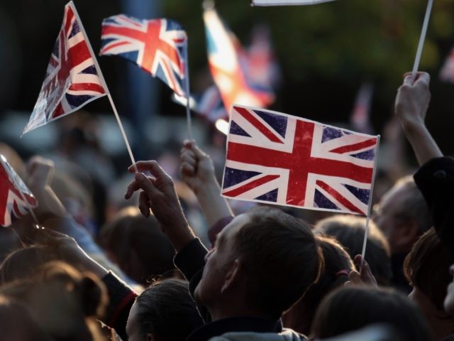 LONDON, ENGLAND - JUNE 04: Diamond Jubilee revelers wave the Union Jack flag in the Mall d