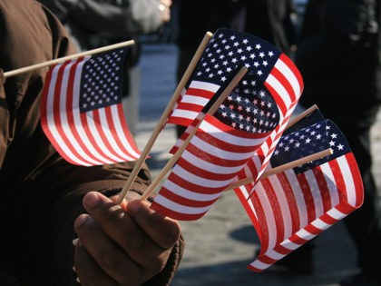 Man holding miniature Amercian flags.