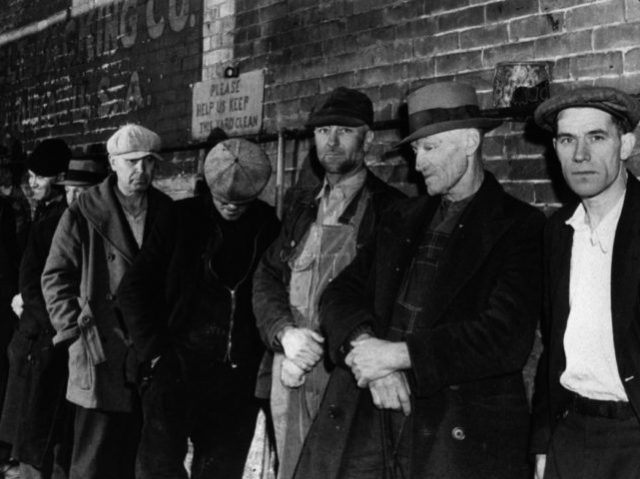 April 1940: A line of men queuing for a meal outside the city mission in Dubuque, Iowa.