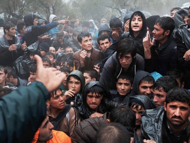 MYTILENE, GREECE - OCTOBER 22: Afghan men argue outside of the main gate as violence escal