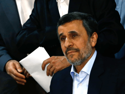 Former Iranian president Mahmoud Ahmadinejad (bottom) and former Iranian Vice President Hamid Baghaei (top) look on at the Interior Ministry's election headquarters as candidates begin to sign up for the upcoming presidential elections in Tehran on April 12, 2017. Ahmadinejad had previously said he would not stand after being advised …