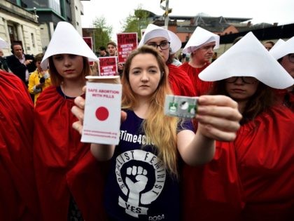 BELFAST, NORTHERN IRELAND - MAY 31: Eleanor Crossey Malone displays an abortion pill packet after taking a pill as abortion rights campaign group ROSA, Reproductive Rights Against Oppression, Sexism and Austerity distribute abortion pills from a touring bus on May 31, 2018 in Belfast, Northern Ireland. Flouting Northern Irish governmental …