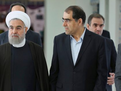 n this photo released by official website of the Iranian Presidency office, President Hassan Rouhani, center, listens to head of Iran's Atomic Energy Organization Ali Akbar Salehi, left, while attending a ceremony marking the national day of nuclear technology in Tehran, Iran, Thursday, April 7, 2016. Rouhani warned on Thursday …