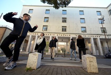 Students walk by Rome's "Giulio Cesare" secondary classic school on March 5, 2020 after Italy closed all schools and universities until March 15 to help combat the spread of the novel coronavirus crisis. - The government decision was announced moments after health officials said the death toll from COVID-19 had …