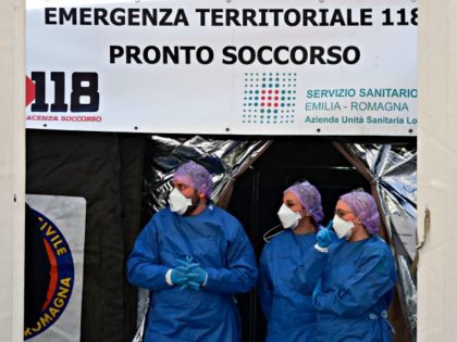 Medical staff wait outside a sanitary tent installed in Piacenza next to the hospital on F