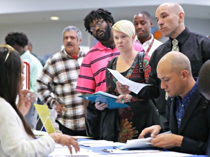 LOS ANGELES, CALIFORNIA - MARCH 05: Job seekers meet with recruiters at a job fair hosted