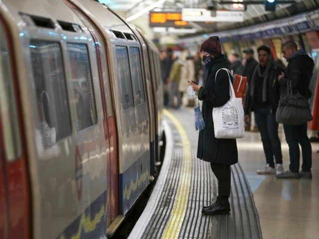 Passenger on the London Underground wears a surgical mask during the Coronavirus pandemic in London on March 12, 2020 in London, England. The Prime Minister announced the UK is entering the "delay" phase of emergency planning for the Covid-19 crisis. Schools will not be closed at this time although they …
