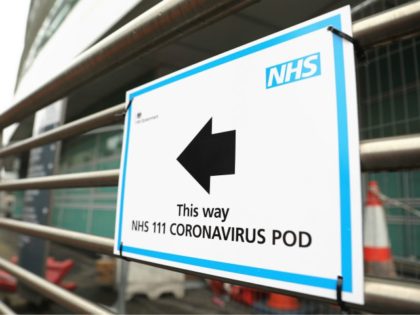 A sign directs directs patients to an NHS 111 Coronavirus Pod testing service area for COVID-19 assessment at University College Hospital in London on March 5, 2020. - The number of confirmed cases of novel coronavirus COVID-19 in the UK rose to 85 on March 4, with fears over the …