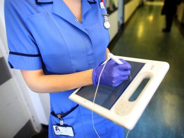 BIRMINGHAM, ENGLAND - MARCH 16: A nurse uses a wireless electronic tablet to order medicines from the pharmacy at The Queen Elizabeth Hospital on March 16, 2010 in Birmingham, England. As the UK gears up for one of the most hotly contested general elections in recent history it is expected …