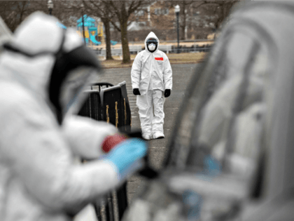 STAMFORD, CT - MARCH 23: Medical personnel dressed in personal protective equipment (PPE) prepare to give a coronavirus swab test at a drive-thru testing station at Cummings Park on March 23, 2020 in Stamford, Connecticut. Availability of protective clothing for medical workers has become a major issue as COVID-19 cases …