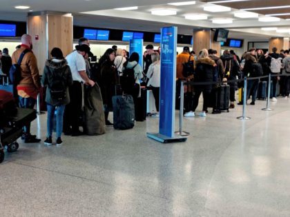 People queue in the departure hall of Terminal 7 at JFK airport on March 15, 2020 in New Y