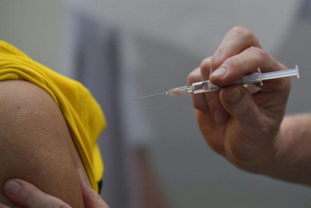 A flu vaccination is injected on the arm of a person during a press event to promote flu vaccinations in Berlin on October 29, 2019. (Photo by Tobias SCHWARZ / AFP) (Photo by TOBIAS SCHWARZ/AFP via Getty Images)