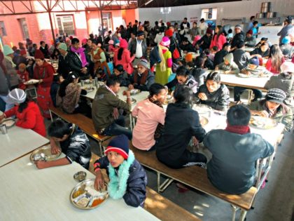 Bhutanese refugees lunch at a camp in Kathmandu before leaving for the United States on De