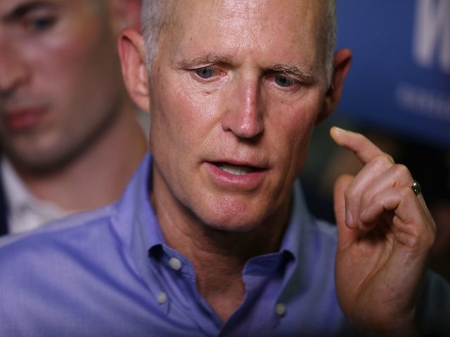 Florida governor and Republican senatorial candidate Rick Scott speaks to the media as he