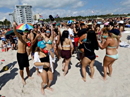 FILE - In this March 14, 2016, file photo, spring breakers gather in South Beach, at Miami