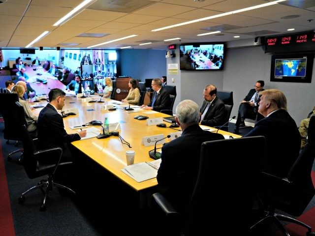 WASHINGTON, DC - MARCH 19: President Donald Trump, right, attends a teleconference with governors at the Federal Emergency Management Agency headquarters, on March 19, 2020 in Washington, DC. With Americans testing positive from coronavirus rising President Trump is asking Congress for $1 trillion aid package to deal with the COVID-19 …