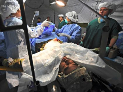 US military medics treat a mock victim in a tent during a joint medical evacuatioin exercise as part of the annual massive military exercises, known as Key Resolve and Foal Eagle, at a South Korean Army hospital in Goyang, northwest of Seoul, on March 15, 2017. South Korea and the …