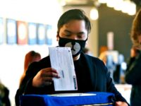 © Jason Redmond/AFP via Getty Images Matthew Guerrero, 22, of Des Moines, Washington wears a bear mask as he drops off his presidential primary mail-in ballot in person at King County Elections in Renton, Washington, March 10, 2020.
