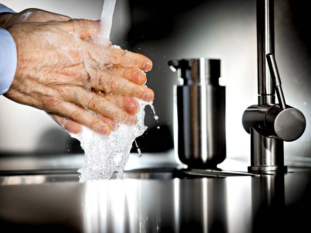 An illustraton picture shows a person washing their hands with disinfectant soap on March