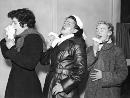 Three volunteers are infected with the common cold virus for research purposes at the Harvard Hospital in Wiltshire, 28th December 1955. From left to right, they are student Brenda Jeanes, German tourist Anne Weddig and civil servant Pat Brown. (Photo by FPG/Hulton Archive/Getty Images)