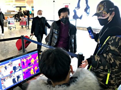 FILE - In this Jan. 21, 2020, file photo, travelers pass through a health screening checkpoint at Wuhan Tianhe International Airport in Wuhan in southern China's Hubei province. For weeks after the first reports of a mysterious new virus in Wuhan, people poured out of the central Chinese city, cramming …