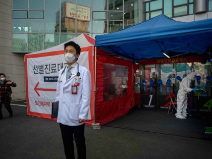 Hospital president Kim Sang-il (C) stands outside a COVID-19 novel coronavirus testing boo