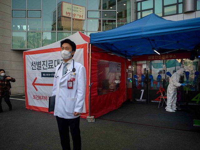 Hospital president Kim Sang-il (C) stands outside a COVID-19 novel coronavirus testing booth at Yangji hospital in Seoul on March 17, 2020. - A South Korean hospital has introduced "phone booth"-style coronavirus testing facilities that avoid medical staff having to touch patients directly and cut down disinfection times. (Photo by …