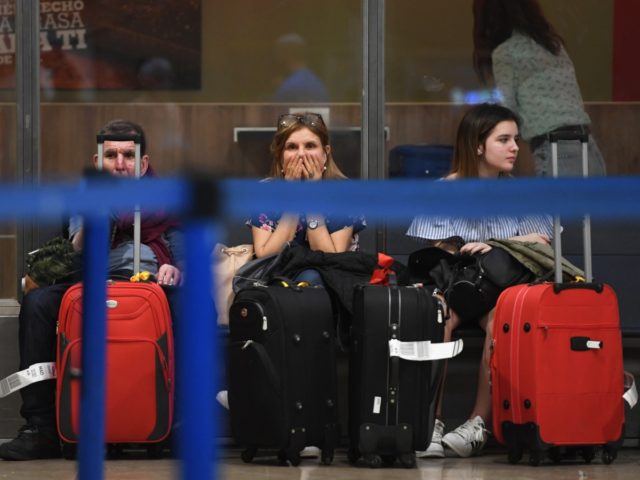 Passengers wait near the Ryanair check-in counters at Adolfo Suarez Madrid Barajas airport