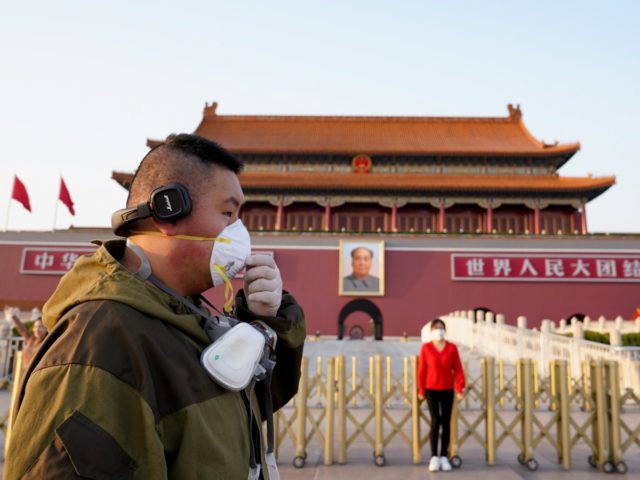 BEIJING, CHINA - MARCH 16: A Chinese man wears a protective mask as he visit Tiananmen Gat