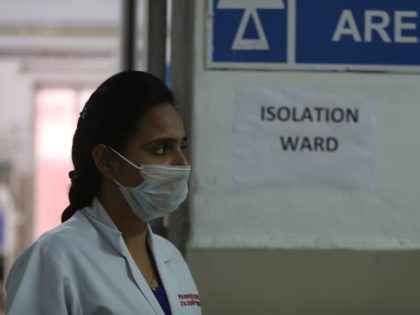 An Indian doctor stands outside a special ward set aside for possible COVID-19 patients at
