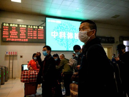 Passengers wearing face masks wait for a train to arrive at Jiujiang railway station in Jiujiang, a city which sits on the border between Chinas central Jiangxi province and Hubei province, the epicentre of the country's COVID-19 coronavirus outbreak, on March 18, 2020. (Photo by NOEL CELIS / AFP) (Photo …