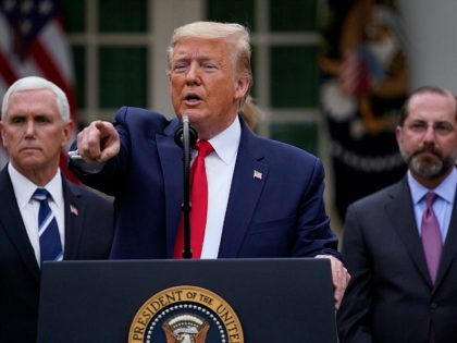 President Donald Trump takes questions during a news conference about the coronavirus in the Rose Garden of the White House, Friday, March 13, 2020, in Washington. Vice President Mike Pence, left, and Department of Health and Human Services Secretary Alex Azar, right listen. (AP Photo/Evan Vucci)