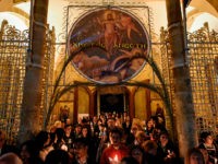 Cypriot Greek Orthodox worshippers stand outside Faneromeni church in the old city of Nicosia, carrying candles during the Easter Saturday vigil after midnight on April 16, 2017. / AFP PHOTO / Amir Makar (Photo credit should read AMIR MAKAR/AFP via Getty Images)