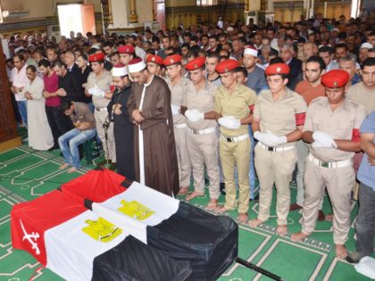 Egyptians pray over the coffins of an army officer Ahme Abou Baker and a soldier Ahmed Moh