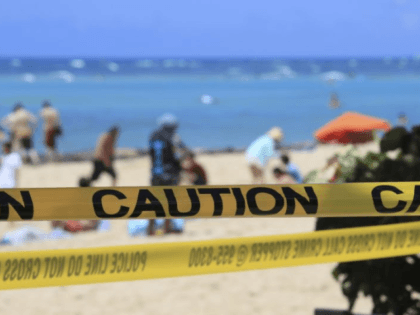 In this Friday, March 20, 2020, file photo, as beachgoers are seen in the background, yellow caution tape wrapped across Waikiki in Honolulu. Hawaii's governor has instituted a mandatory 14-day self quarantine starting Thursday, March 27, of all people traveling to the state as part of efforts to fight the …