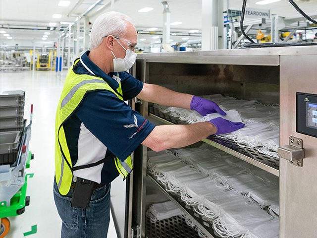 Engineers and technicians set-up and test the machines that will be used to manufacture Level 1 face masks Monday, March 30, 2020 at the General Motors Warren, Michigan manufacturing facility. Production will begin next week and within two weeks ramp up to 50,000 masks per day, with the potential to …