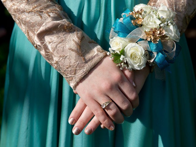 Nails freshly manicured Hannah Shraim, 17, wears a wrist corsage as she meets her friends