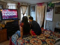NORWALK, CT - MARCH 25: Undocumented immigrant Juana, 24, from El Salvador and her husband Saul, 23, from Honduras watch local news in their one-room apartment on March 25, 2020 in Norwalk, Connecticut. Juana lost her job as a house cleaner and Saul as a painter due to the coronavirus …