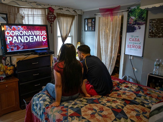 NORWALK, CT - MARCH 25: Undocumented immigrant Juana, 24, from El Salvador and her husband Saul, 23, from Honduras watch local news in their one-room apartment on March 25, 2020 in Norwalk, Connecticut. Juana lost her job as a house cleaner and Saul as a painter due to the coronavirus …