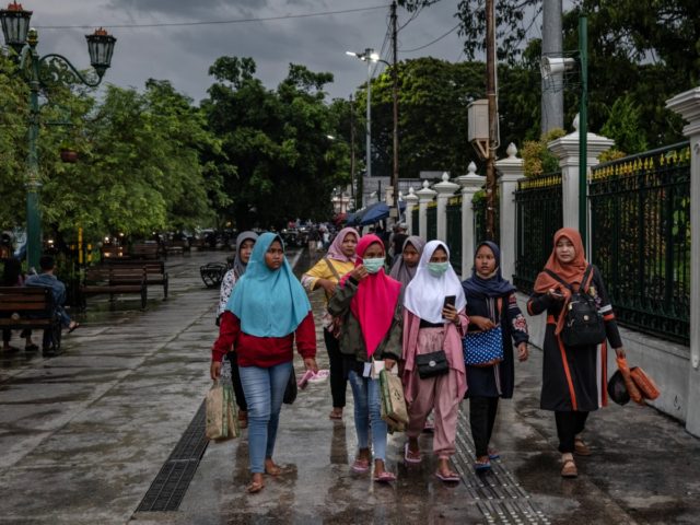 YOGYAKARTA, INDONESIA - MARCH 03: Indonesian women wear protective masks walk on the stree