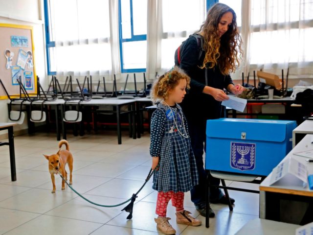 Israelis vote at a polling station in Tel Aviv during parliamentary election on March 2, 2
