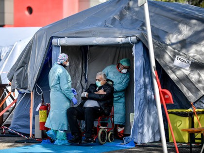 An elderly patient is attended in one of the emergency structures that were set up to ease procedures outside the hospital of Brescia, Northern Italy, Tuesday, March 10, 2020. For most people, the new coronavirus causes only mild or moderate symptoms, such as fever and cough. For some, especially older …